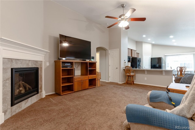5131 Delphinium Cir, Brighton, CO 80601 - living room featuring light carpet, ceiling fan, arched walkways, a tile fireplace, and recessed lighting