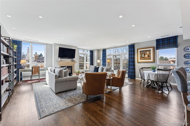 living room featuring dark wood-type flooring and floor to ceiling windows