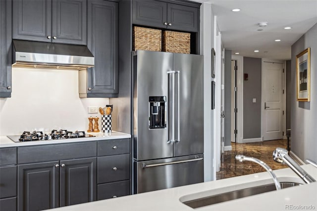 kitchen with sink, black gas stovetop, and high end refrigerator