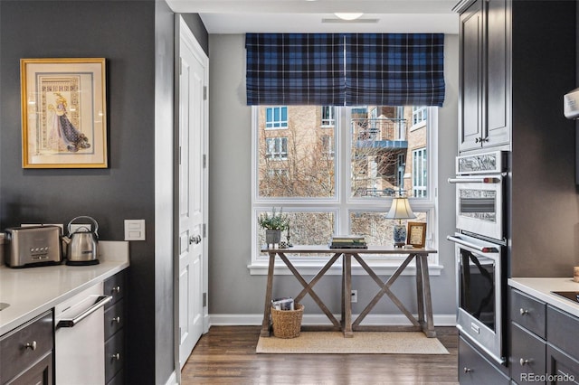 kitchen featuring dark hardwood / wood-style flooring and double oven