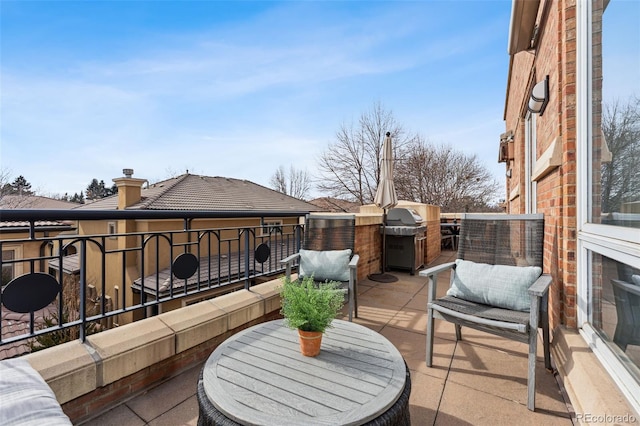 view of patio / terrace featuring area for grilling and a balcony