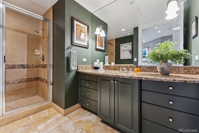 bathroom featuring vanity and a shower with shower door