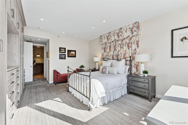 bedroom with light colored carpet and ensuite bath