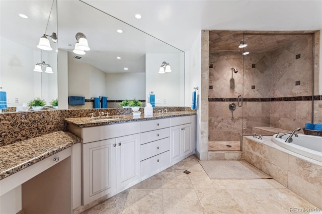 bathroom featuring tile patterned floors, vanity, and shower with separate bathtub