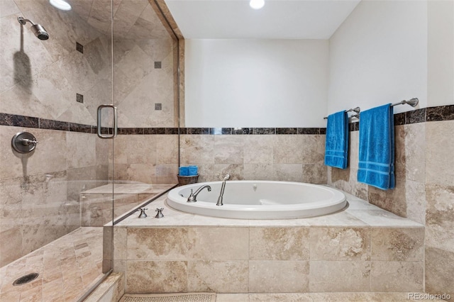 bathroom featuring separate shower and tub