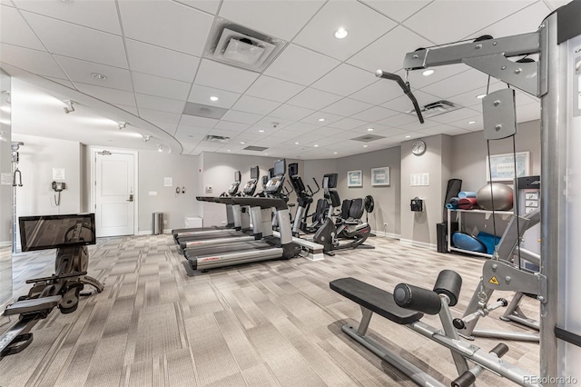 exercise room with light carpet and a drop ceiling