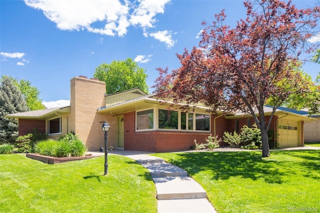 6600 E 4th Ave, Denver, CO 80220 - view of front of home featuring brick siding, an attached garage, and a front yard