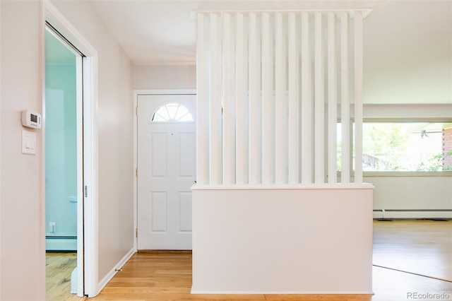 6600 E 4th Ave, Denver, CO 80220 - entrance foyer with light wood finished floors and a baseboard radiator