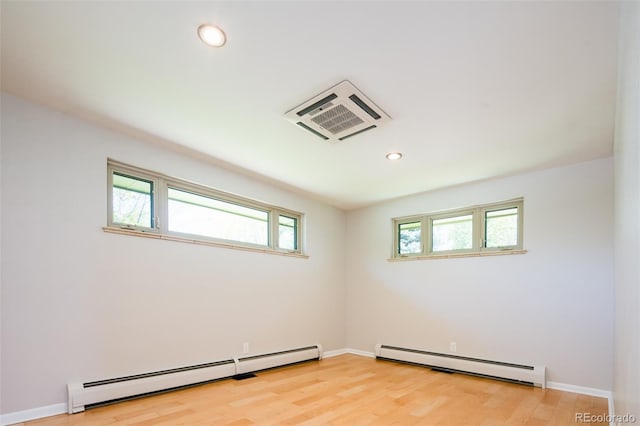 6600 E 4th Ave, Denver, CO 80220 - empty room with a baseboard heating unit, recessed lighting, light wood-style flooring, and baseboards