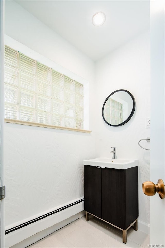 6600 E 4th Ave, Denver, CO 80220 - bathroom featuring baseboard heating, vanity, and tile patterned flooring
