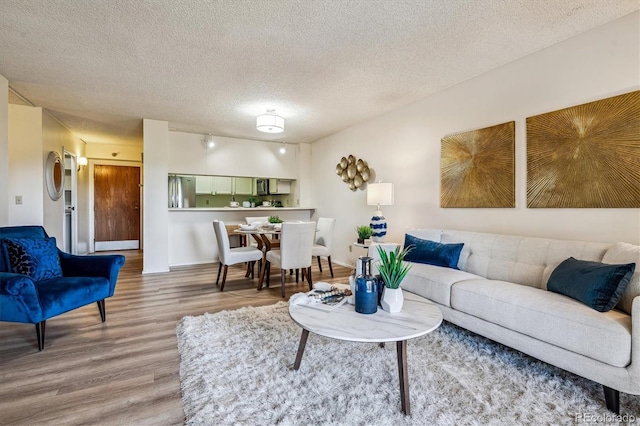7420 E Quincy Ave Unit 304, Denver, CO 80237 - living room featuring wood finished floors and a textured ceiling