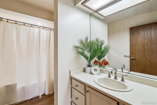 7420 E Quincy Ave Unit 304, Denver, CO 80237 - bathroom featuring vanity, wood finished floors, and a skylight