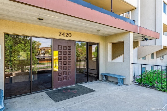 7420 E Quincy Ave Unit 304, Denver, CO 80237 - view of exterior entry with stucco siding