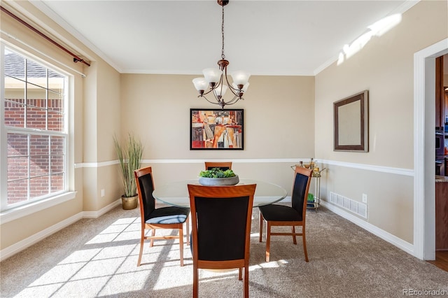 dining space featuring ornamental molding, a wealth of natural light, visible vents, and baseboards