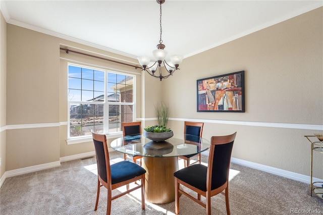 carpeted dining room with baseboards, a chandelier, and crown molding