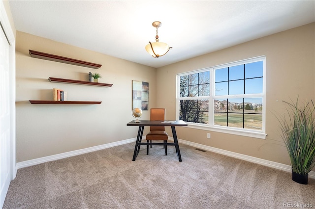 unfurnished office featuring carpet, visible vents, and baseboards