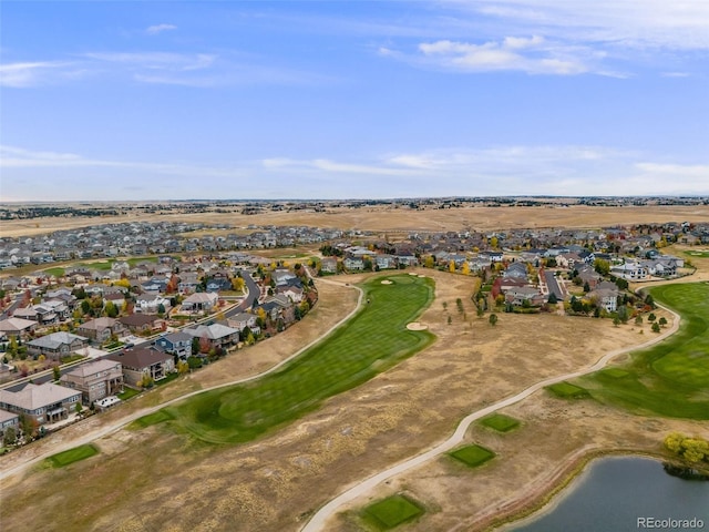 drone / aerial view featuring a residential view, a water view, and golf course view