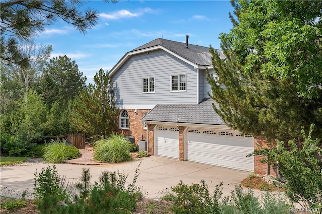 18963 E Long Ave, Centennial, CO 80016 - view of front of house with concrete driveway, brick siding, and an attached garage