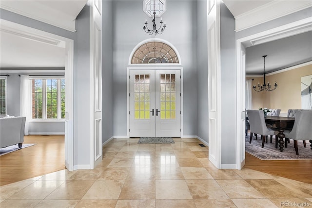 18963 E Long Ave, Centennial, CO 80016 - entrance foyer featuring a chandelier, crown molding, french doors, and light tile patterned flooring