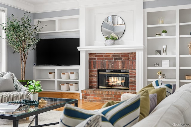 18963 E Long Ave, Centennial, CO 80016 - living area with a brick fireplace, ornamental molding, built in shelves, and wood finished floors