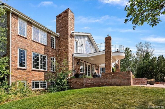 18963 E Long Ave, Centennial, CO 80016 - rear view of house with a lawn, a balcony, a chimney, and brick siding