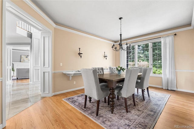 18963 E Long Ave, Centennial, CO 80016 - dining space with a chandelier, crown molding, and light wood-style flooring