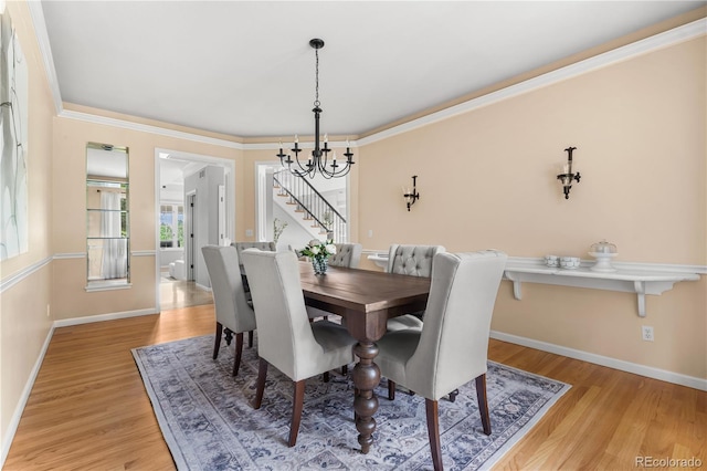 18963 E Long Ave, Centennial, CO 80016 - dining space with a chandelier, light wood-type flooring, stairway, and ornamental molding