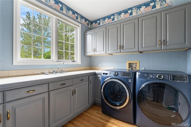18963 E Long Ave, Centennial, CO 80016 - laundry area with cabinet space, washing machine and clothes dryer, and light wood-style floors