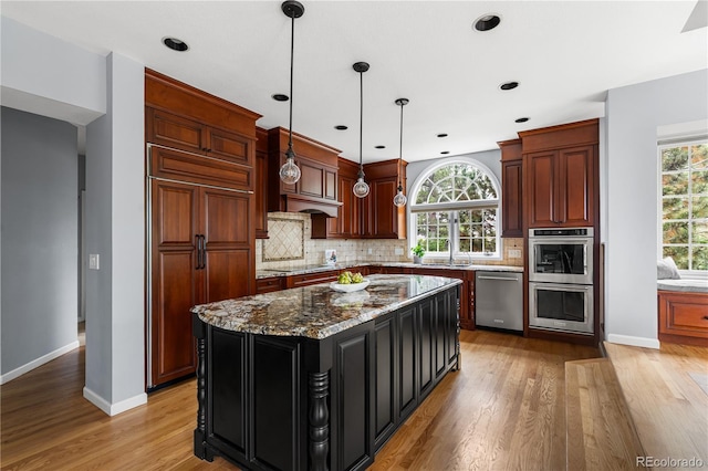18963 E Long Ave, Centennial, CO 80016 - kitchen with appliances with stainless steel finishes, light wood-type flooring, backsplash, pendant lighting, and light stone counters
