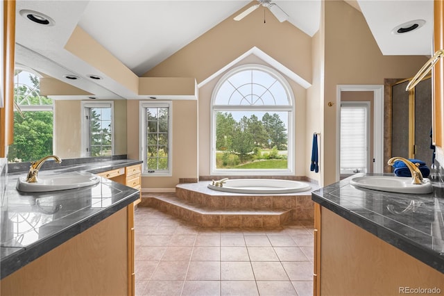 18963 E Long Ave, Centennial, CO 80016 - full bath with lofted ceiling, two vanities, a garden tub, tile patterned flooring, and a ceiling fan