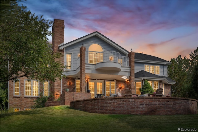 18963 E Long Ave, Centennial, CO 80016 - back of property with a balcony, a chimney, a lawn, and brick siding