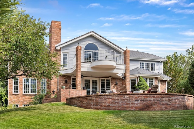 18963 E Long Ave, Centennial, CO 80016 - rear view of house with a balcony, a chimney, a yard, brick siding, and french doors