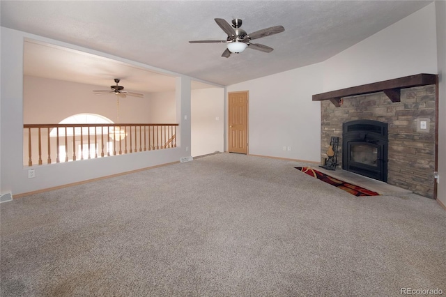 unfurnished living room featuring carpet, ceiling fan, a fireplace, and vaulted ceiling