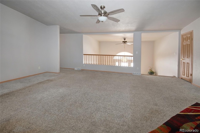 carpeted spare room with ceiling fan