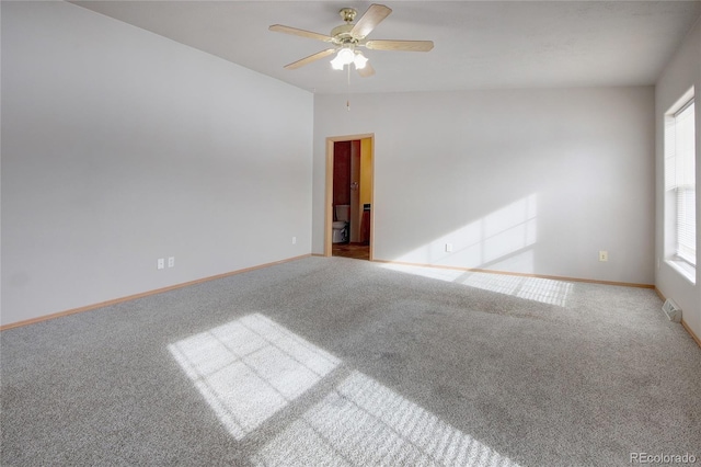 unfurnished room featuring carpet, ceiling fan, and vaulted ceiling