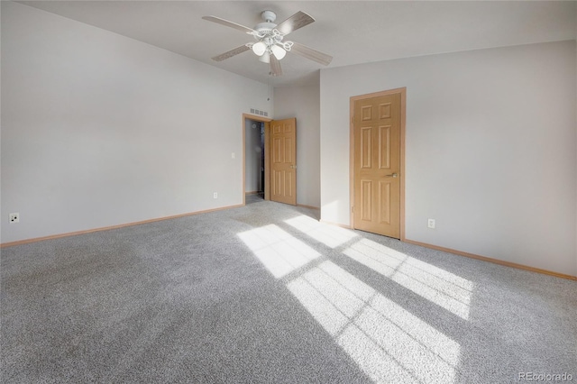 empty room with ceiling fan and carpet