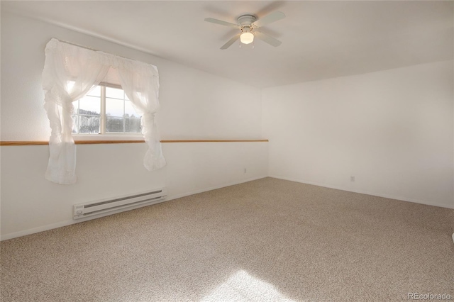 spare room with carpet, ceiling fan, and a baseboard heating unit