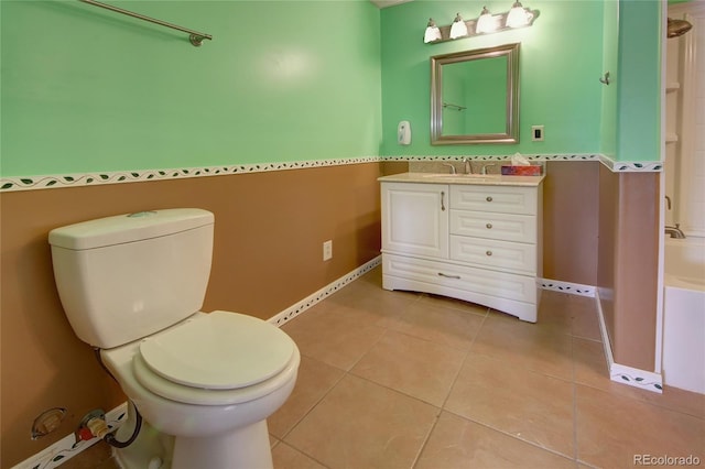 bathroom featuring tile patterned flooring, vanity, and toilet