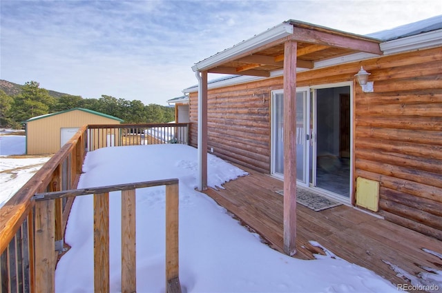 snow covered deck with an outdoor structure