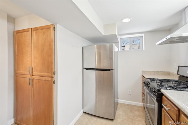 kitchen featuring recessed lighting, appliances with stainless steel finishes, exhaust hood, light countertops, and baseboards