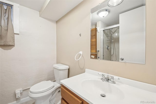 full bathroom with vanity, toilet, and a shower with shower door