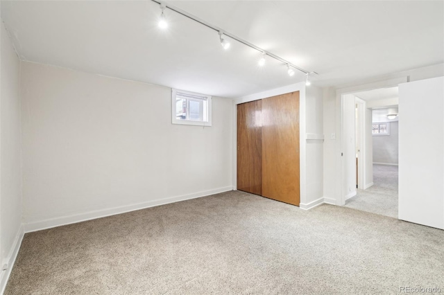 interior space featuring a closet, baseboards, and carpet