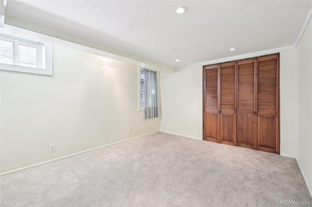 unfurnished bedroom with recessed lighting, a closet, baseboards, and carpet flooring