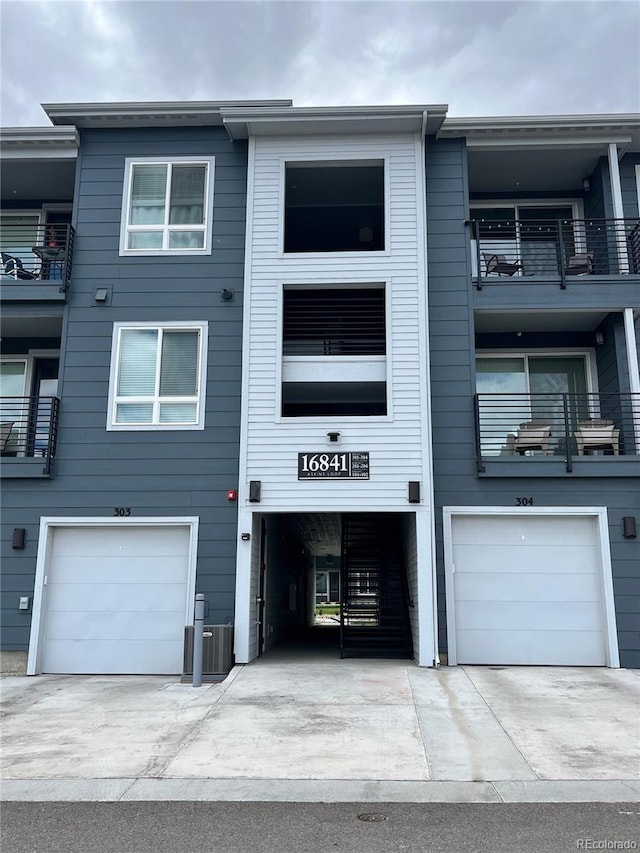 16841 Askins Loop Unit 208, Parker, CO 80134 - view of building exterior with driveway, central AC unit, and a garage