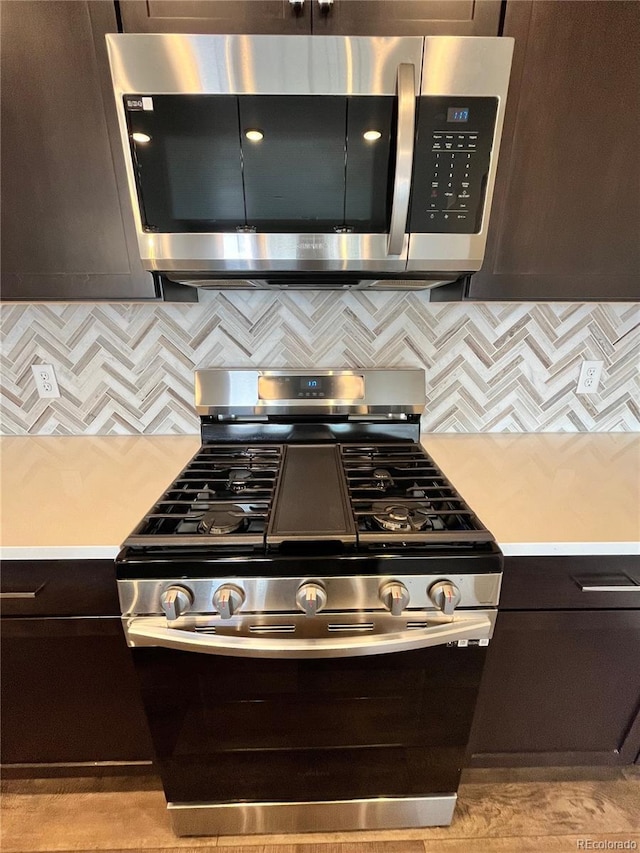 16841 Askins Loop Unit 208, Parker, CO 80134 - kitchen with light countertops, stainless steel appliances, tasteful backsplash, and dark brown cabinets