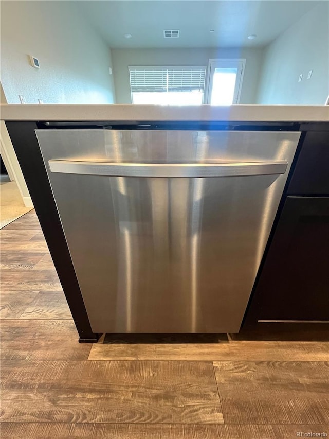 16841 Askins Loop Unit 208, Parker, CO 80134 - interior details featuring stainless steel dishwasher, wood finished floors, and visible vents