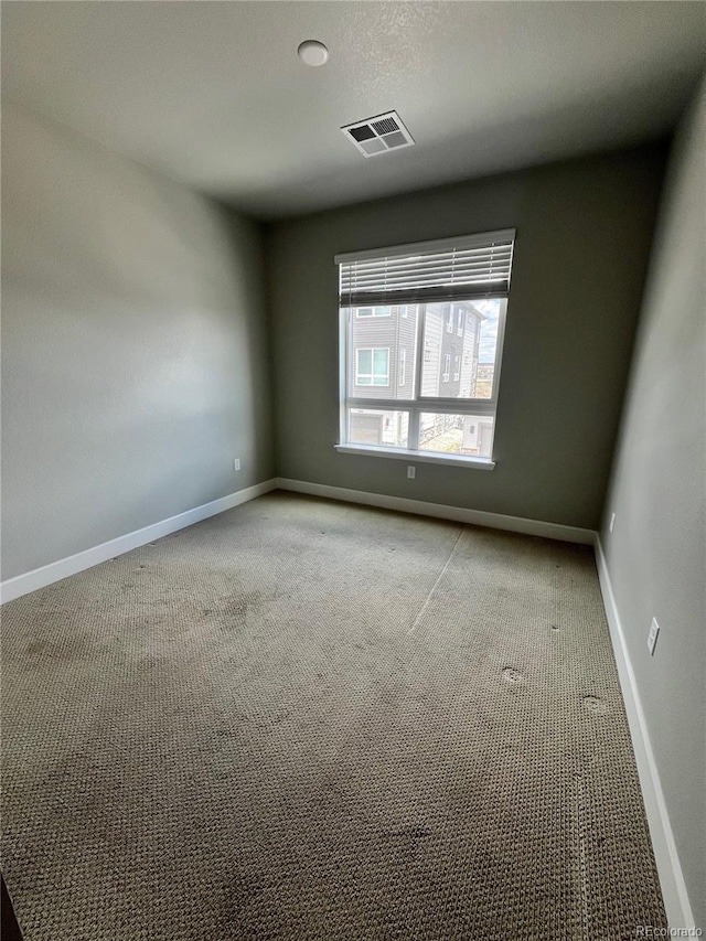 16841 Askins Loop Unit 208, Parker, CO 80134 - spare room with baseboards, visible vents, and light carpet