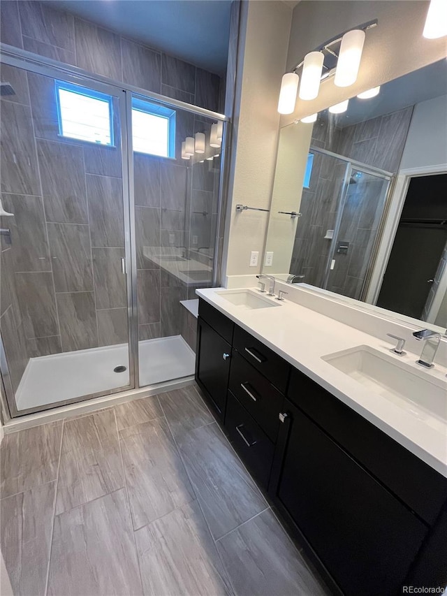 16841 Askins Loop Unit 208, Parker, CO 80134 - full bath featuring a sink, a shower stall, and double vanity