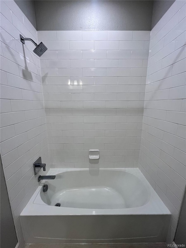 16841 Askins Loop Unit 208, Parker, CO 80134 - bathroom featuring shower / bathtub combination and a textured wall