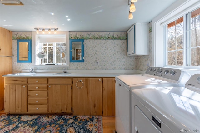 9185 US Highway 285, Salida, CO 81201 - laundry area with cabinet space, washer and clothes dryer, wallpapered walls, and light wood-style floors